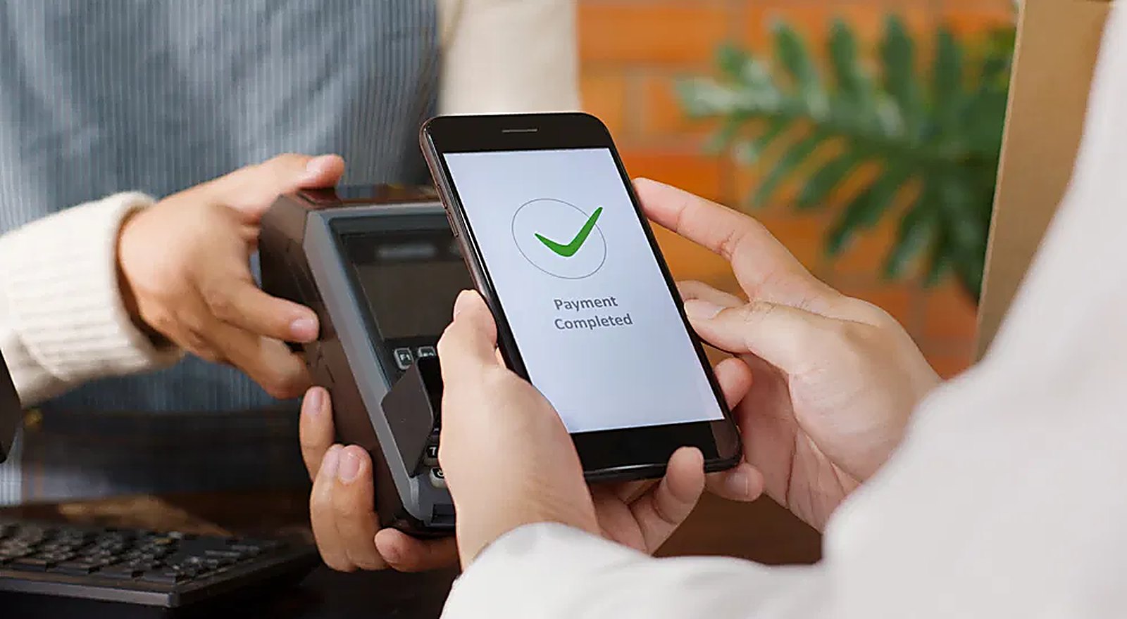 A contactless card payment being completed on a terminal