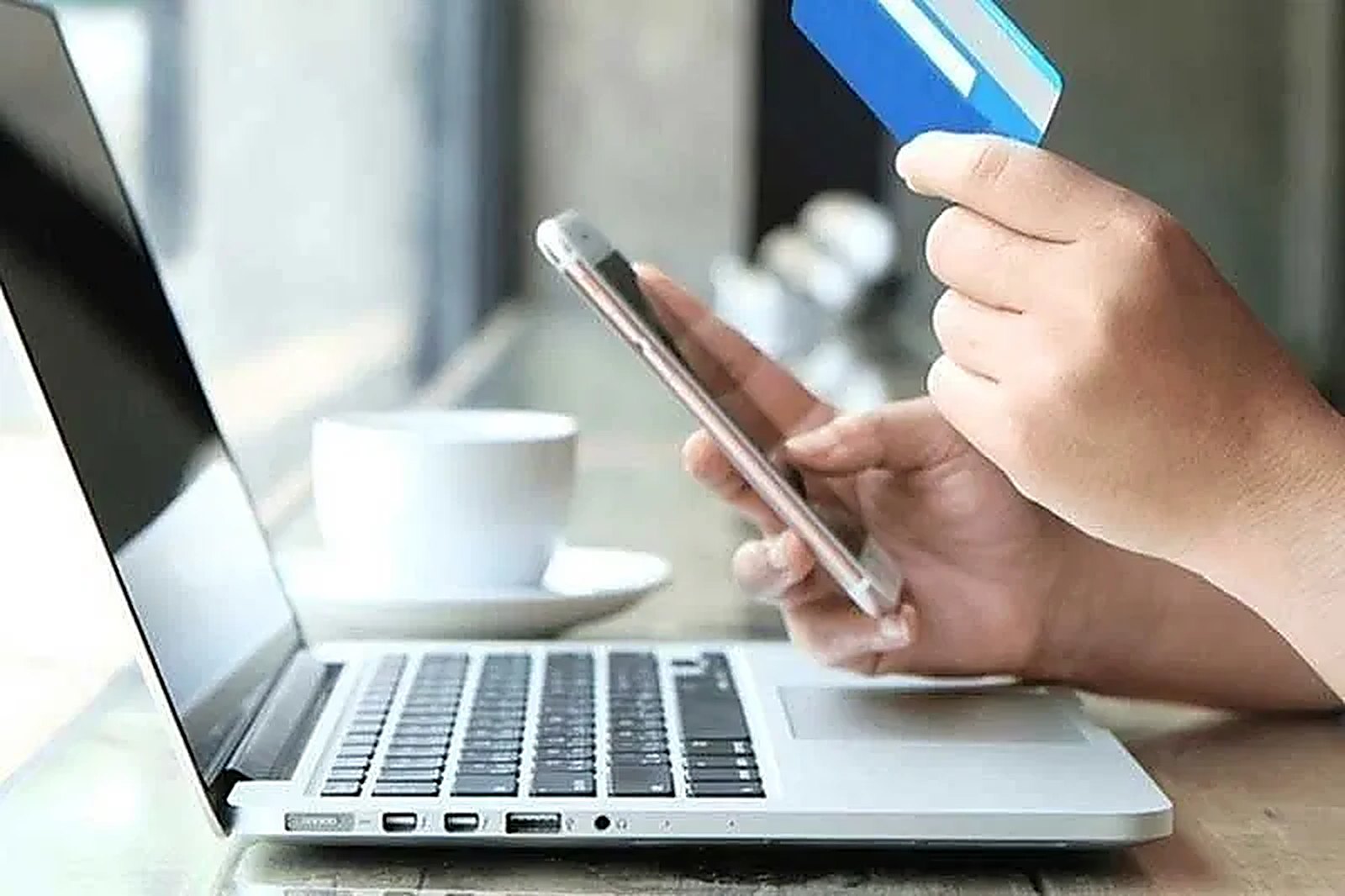 A client paying an invoice online from a laptop and phone